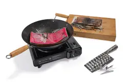untitled 2018 (curry western) by Rirkrit Tiravanija, 2018, portable butane burner, wok, chopping board, cleaver and cut and burned copy of Impulse Interviews, sold Dec 2024