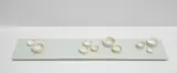 three short walks, II by Edmund de Waal, 2012, 12 thrown porcelain dishes in white and cream glazed with gilding arranged on a hand-pressed porcelain tile in a celadon, offered Jul 2023
