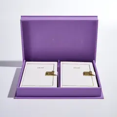 Robert Gober, Heat, 1989, The complete set of two hand-bound books in white leather with gilt title on the cover and metal spring clasps, text Heat by Joyce Carol Oates handwritten by Gober with lithographic endpapers, on Saunders paper, both books contained in the original purple linen-covered portfolio