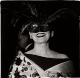 Laughing Woman in a Feather Mask, N.Y.C. by Diane Arbus, 1967, Gelatin silver print, printed later by Neil Selkirk, sold Apr 2023
