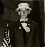 Boy with a straw hat waiting to march in a pro-war parade, N.Y.C. by Diane Arbus, 1967, Gelatin silver print, printed later by Neil Selkirk, sold Apr 2023