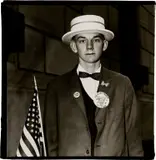 Boy with a straw hat waiting to march in a pro-war parade, N.Y.C. by Diane Arbus, 1967, Gelatin silver print, offered Oct 2023
