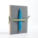Man Ray, Le Pain peint (Painted Bread), 1974, The complete set with 10 pochoirs in colors, three reproductions in colors and a folded exhibition poster in colors mounted on the backboard (as issued), all on wove paper, with title page, contained in the original blue velvet boards with a blue painted baguette multiple mounted on the front cover