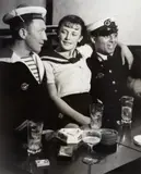 Conchita with sailors in a café on the Place d’Italie by Christian Bérard, circa 1933, Gelatin silver print, printed later, sold Apr 2022