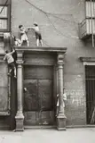 Helen Levitt, N.Y.C. (boys playing over doorway)