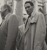 Dorothea Lange, New York City (man in raincoat)