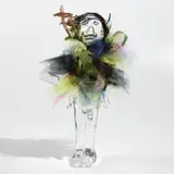 Pascale Marthine Tayou, (Poupée Pascale), 2010, crystal figure, feathers, wood, string, toy shark tail, textiles and plastic mesh, foliage and cord assemblage