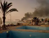 Simon Norfolk, Storage Depot for Power Station Jiyeh, from Sand’s Rock Resort, Lebanon, 2006, Chromogenic print