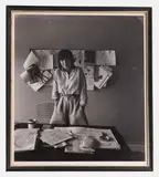 Arnold Newman, Dame Mary Quant, 1978, a bromide print photograph of Mary Quant standing in front of her work desk
