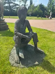 Marion Smith, Untitled, a bronze resin figure of a boy holding a recorder