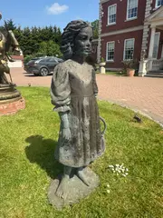 Marion Smith, Untitled, a bronzed resin figure of a girl holding a basket