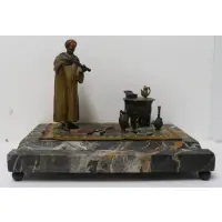 Franz Bergman, Untitled, An Arab on a Persian carpet with rifles, raised on a marble base