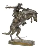 The Bronco Buster by Frederic Remington, bronze with dark brown patina and verdigris, offered Nov 2018