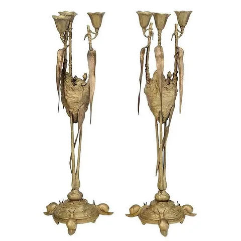 August Nicholas Cain, Untitled, pair of bronze three light candle holders raised on bamboo supports surrounding a birds nest with chicks