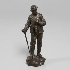 Eutrope Bouret, 'Sortie De La Mine', a patinated bronze study of a miner carrying a lamp