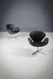 A Pair Of Brown Leather Swan Chairs by Arne Jacobsen, by ARNE JACOBSEN for FRITZ HANSEN, sold Nov 2025