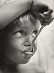 František Dostál, Good Appetite, gelatin silver print depicting a close-up of a child’s face eating with a spoon