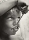František Dostál, Good Appetite, gelatin silver print depicting a close-up of a child’s face eating with a spoon