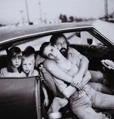 Mary Ellen Mark, Homeless Damm Family in Their Car, 1987, photograph portrays an American family living in their car during a period of growing soci
