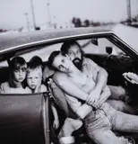 Mary Ellen Mark, Homeless Damm Family in Their Car, 1987, photograph portrays an American family living in their car during a period of growing soci