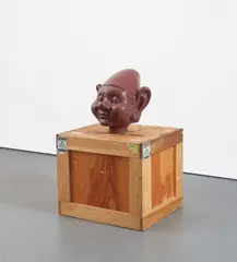 Dwarf Head (chocolate) by Paul McCarthy, 2000, platinum-based silicone and wood crate, sold Feb 2019