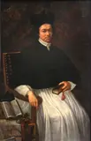 Spanish School, A portrait of a cleric, three-quarter length, seated, holding a book