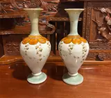 Pair Of European Art Nouveau Ceramic Vases, Untitled, A decorative pair of art-nouveau inspired European vases with a flared neck and footed base, late 19th / early 20th century, with pale celadon colours on neck and foot, with white main body on which t