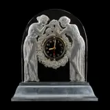 René Lalique (French, 1860–1945) A 'Deux Figurines' Mantel Clock, Designed 1926 by René Lalique, glass, moulded and frosted, on illuminated metal pedestal mount, sold Feb 2026