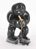 Willie Weetaluktuk, Untitled - Fisherman, 1985, black stone and mixed media sculpture