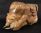 Benj Manuel, Bear on Walrus, brown and yellow stone and bone sculpture