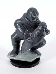 Man and Seal by Nalookie Quananack, 1979, dark grey stone carving, sold Sep 2022