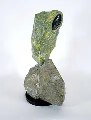 Mattiusi Iyaituk, Not Knowing What Kind of Fish She is Catching from the Deep Lake, 2000, green and grey stone carving with caribou sinew