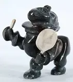 Juili Kutsiq, Untitled - Fantastic Drummer, 1989, grey and brown stone carving