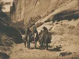 Three Mounted Navajo Women and Child on Horseback by Edward S. Curtis, 1904, toned photograph on paper, sold May 2011