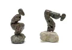 Stella Shawzin, Crouching Figures, two, bronze with a brown patina, on a natural stone base