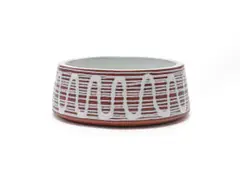 Bowl with white wave pattern by Kalahari Studio, terracotta with overglaze slip trail decoration, offered Jun 2026