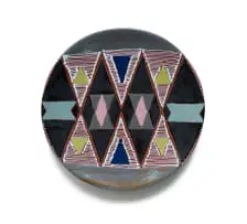Plate decorated with Ndebele triangular pattern by Kalahari Studio, painted terracotta with slip trail glaze, sold Feb 2025