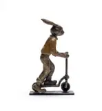 Carol Cauldwell, Rabbit on a Scooter, painted and patinated bronze with wax, on a painted steel base
