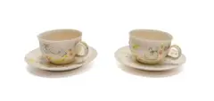 Katherine Glenday, Set of two cups and saucers with angel and banana motifs, two, painted and glazed porcelain