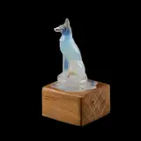 René Lalique (French, 1860-1945), 'Chien', A Model Of A Dog by René Lalique, glass, likely the centre of a cendrier, now mounted on a wooden block, sold Sep 2025