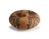 Beauty Ngxongo, An ilala palm Izichumo and cover, circa 2000, the conical body woven with dyed olive green, black and brown geometric motifs