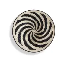 A Tintsaba coiled sisal basket, 2023 by Tintsaba Alice Ndwandwa, woven in black and cream spiral pattern, sold Feb 2024