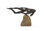 Carl Roberts, Horizontal Figure on Rock, bronze with a dark brown patina, on a stone base