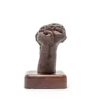 Head by Martin Qgibinsizi Tose, bronze with dark brown patina, on a wooden base, sold Feb 2024