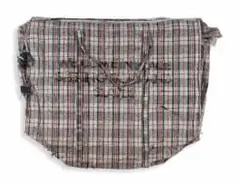 Dan Halter, We Come in Peace Seeking Gold and Slaves, 2014, found plastic weave bag with custom woven tartan