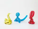 Three works: (i) Balloon Swan (Yellow) ; (ii) Balloon Rabbit (Red) ; (iii) Balloon Monkey (Blue) by Jeff Koons, 2017, mirror-polished stainless steel with transparent color coating, sold Nov 2019
