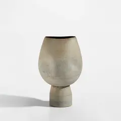 Hans Coper, Footed pot with four indents, circa 1975, Stoneware, layered white porcelain slips and engobes over a textured and incised body, the interior with a manganese glaze