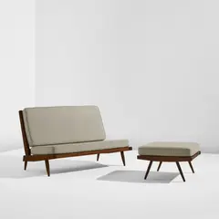 Settee and ottoman by George Nakashima, 1954, American black walnut, fabric upholstery, sold Dec 2025