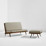 Settee and ottoman by George Nakashima, 1954, American black walnut, fabric upholstery, sold Dec 2025