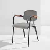 Jean Prouvé, "Conference" chair, model no. 355, circa 1953, Painted steel, oak, vinyl upholstery, rubber